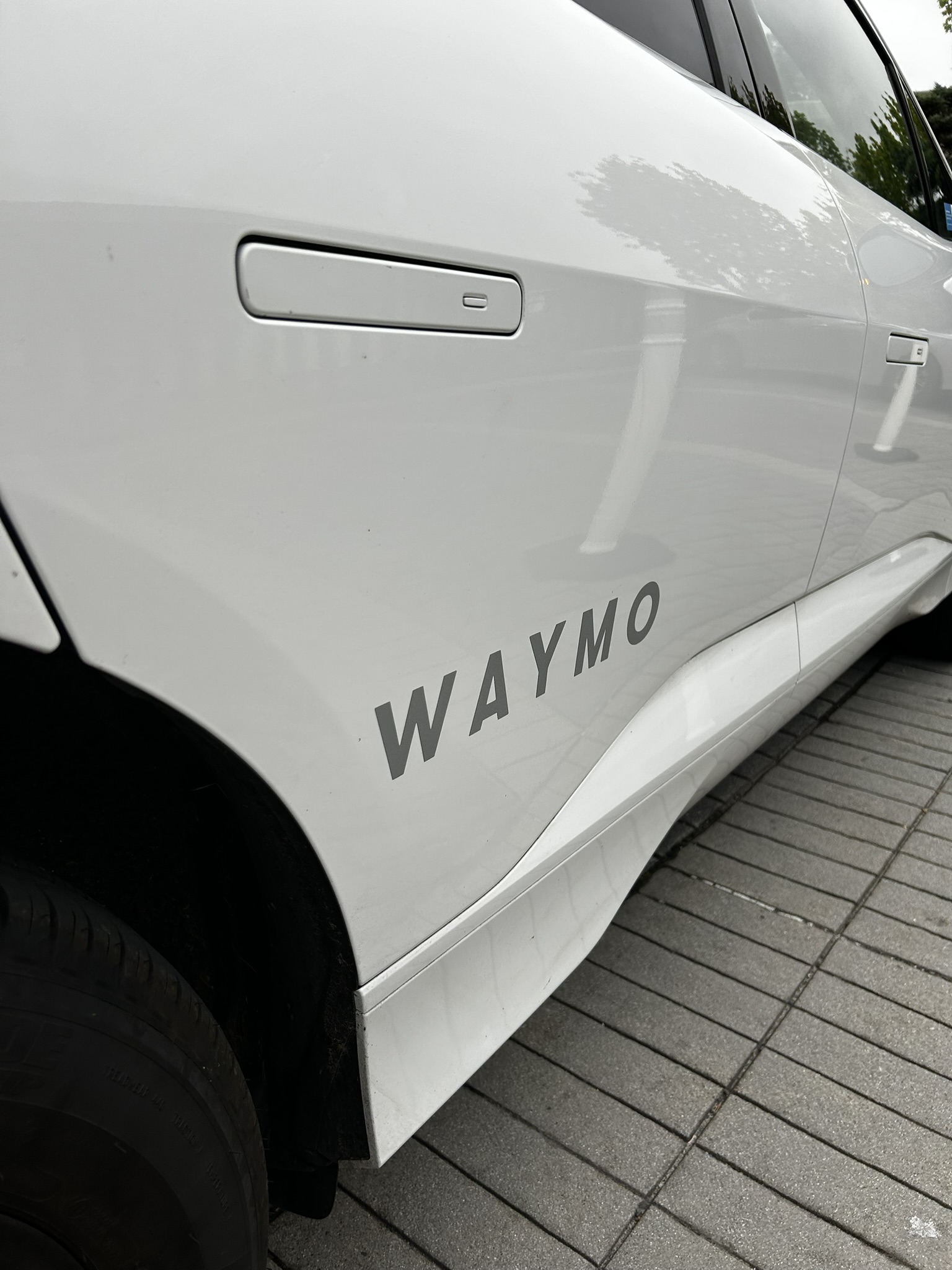 WAYMO branding on the side of the Jaguar I-PACE